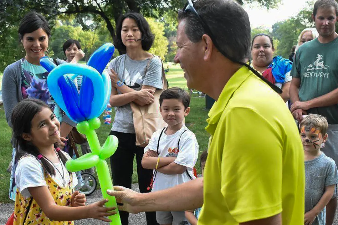 A child and family enjoying interactive entertainment together at a company family event