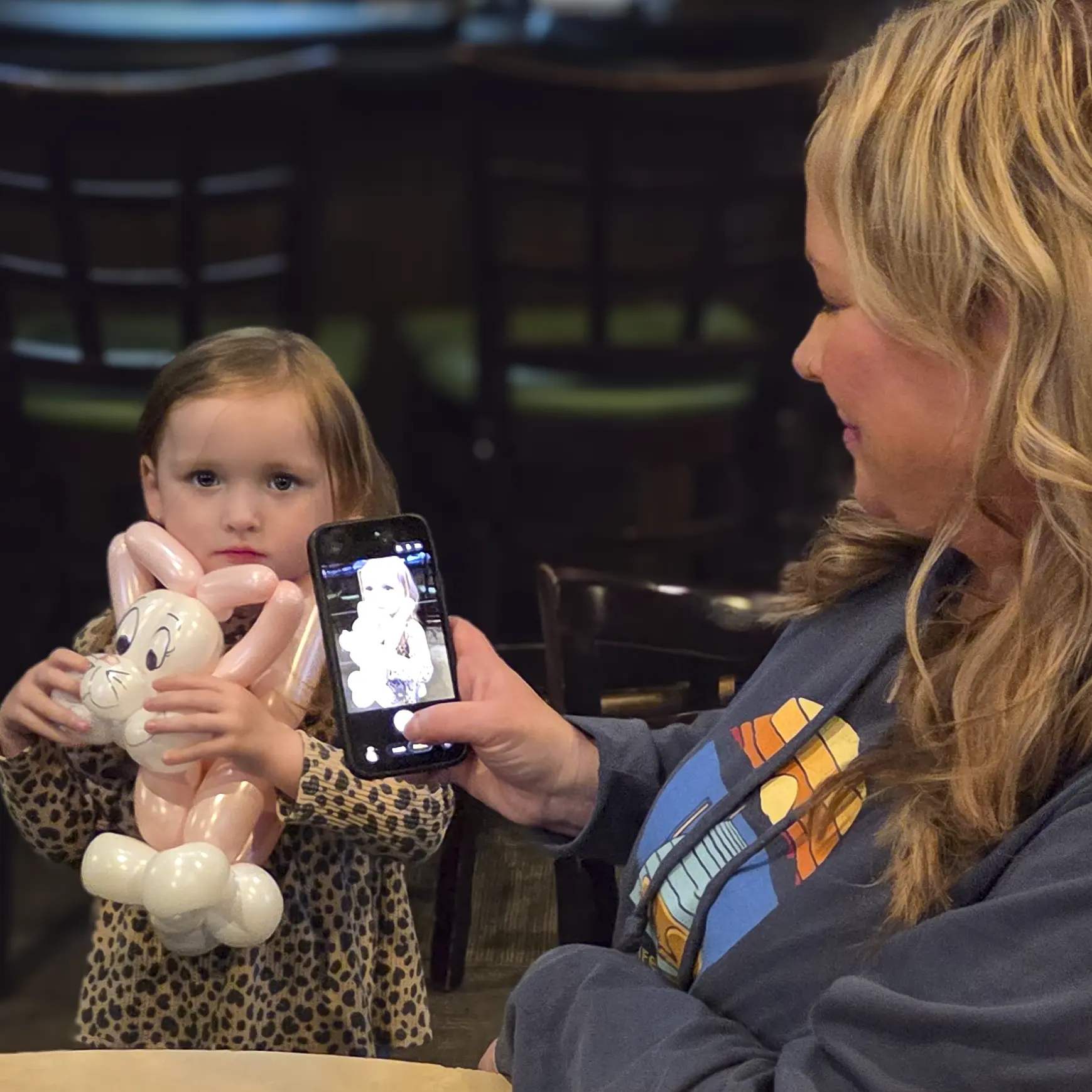 A parent taking a picture of a child enjoying the finished creation during family entertainment