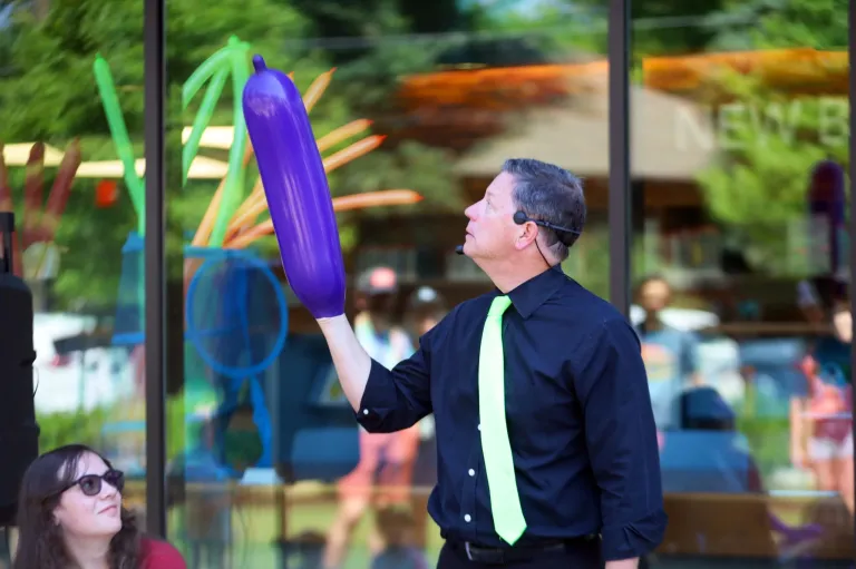 Dale Obrochta performing with an oversized balloon during The Art of Inflation stage show