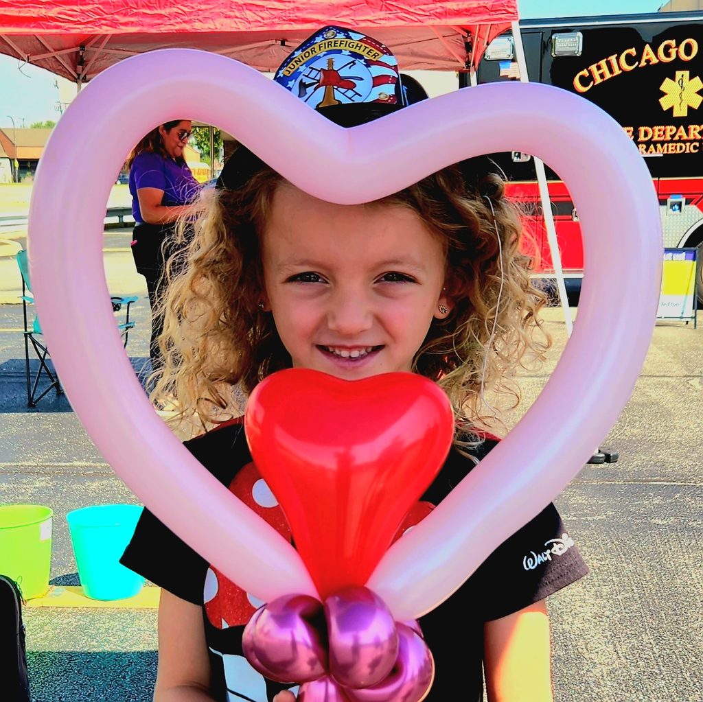 Child holding a balloon creation at the BankFinancial customer appreciation event