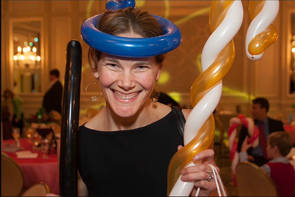 Adult guest enjoying interactive balloon entertainment at a corporate holiday party in Chicago